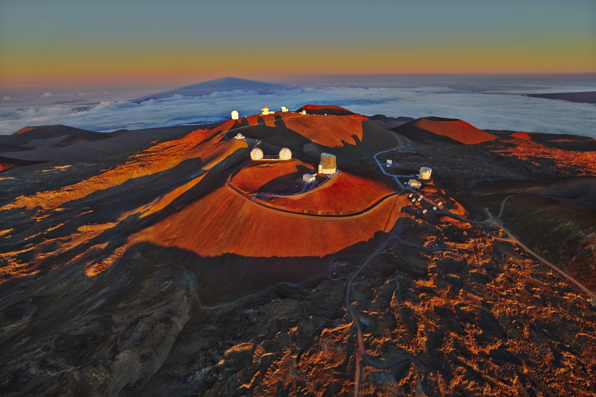 Top of Mauna Kea shaved off for the 13 telescopes already built. The Mauna is littered by these structures.